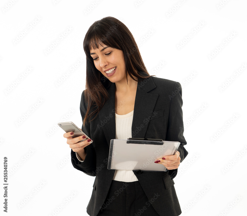 Portrait of a young happy attractive business woman checking emails and texting on mobile phone Portrait of a young happy attractive business woman checking emails and texting on mobile phone