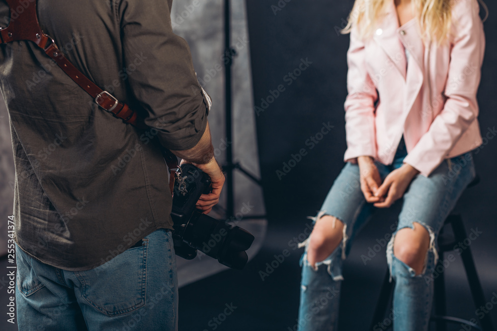 young man with a camera and a girl having a business conversation, close up cropped photo