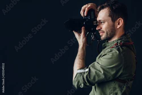 Side view photo of a handsome man taking photo with digital camera.close up side view photo, copy spacem hobby, profession