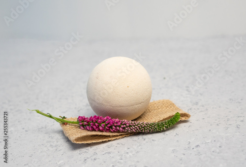 Pink juicy strawberry smell bath bomb on tray in bath room, relaxing aroma salt and candle. Therapy concept. Taking a relaxing bath. Lifestyle.