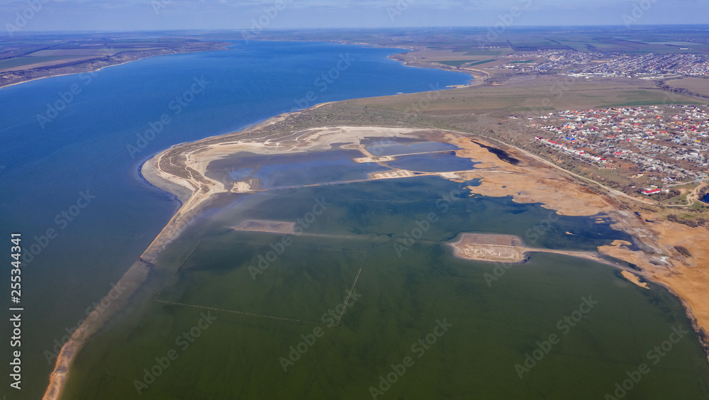 Top view of the coastal zone of the ecological reserve Kuyalnik estuary, Odessa, Ukraine. Aerial view from drone to sea estuaries in a suburban area near urban buildings