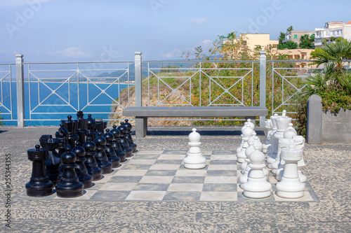 Street chess game on the background of the sea photo