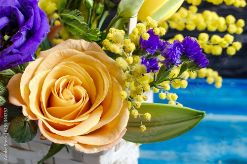 Flower arrangement close-up of fresh flowers of red yellow blue orange flowers in a wicker basket