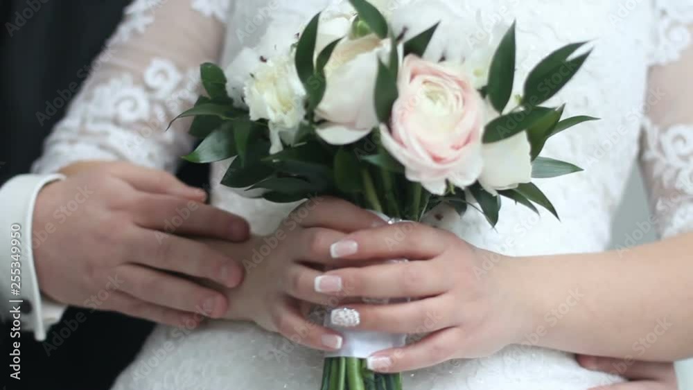 groom gently touches his hand on the hand of the bride groom gently touches his hand on the hand of the bride