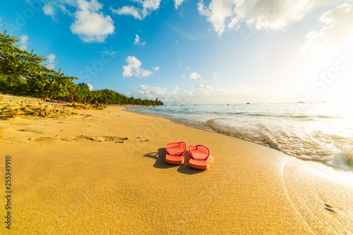 Flip flops on the sand in Le Souffleur beach in Guadeloupe