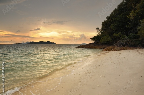 Sunset on the tropical sandy beach on the Koh Chang island in Thailand.