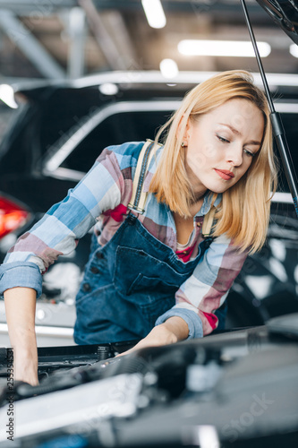 Vászonkép puzzled girl have problems with engine