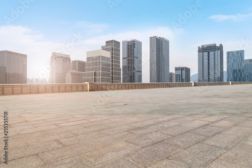 Urban skyscrapers with empty square floor tiles © 昊 周