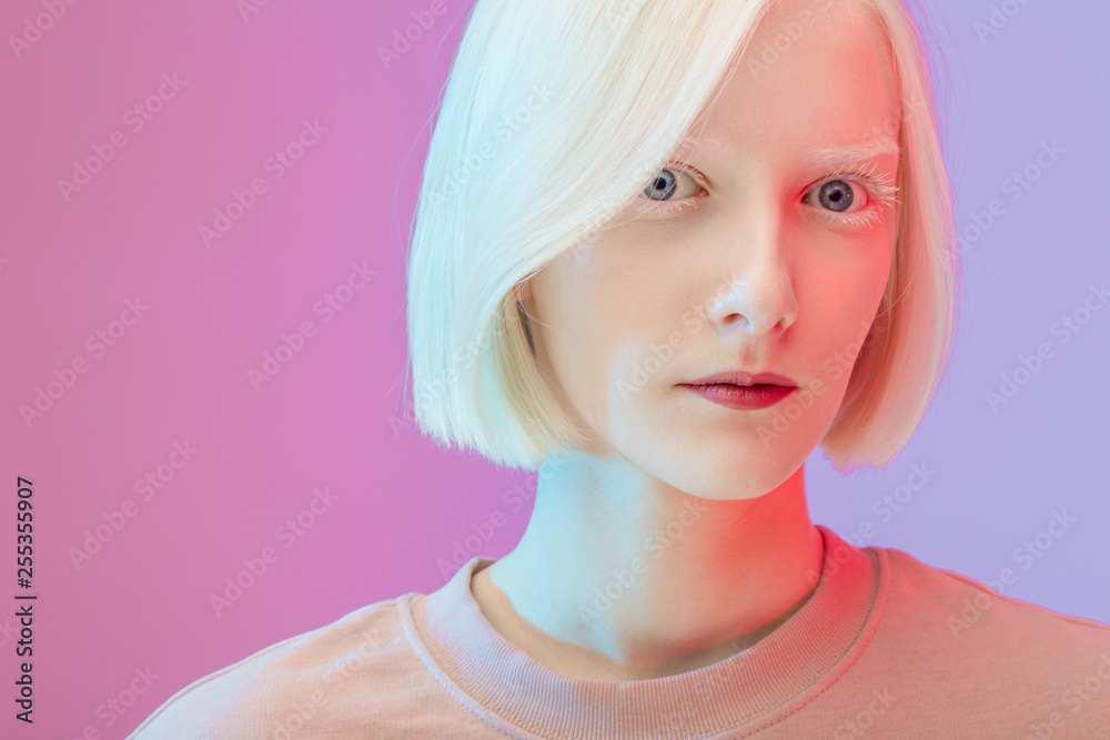 attractive girl with short fair hair looking at the camera, isolated pink background,close up photo attractive girl with short fair hair looking at the camera, isolated pink background,close up photo