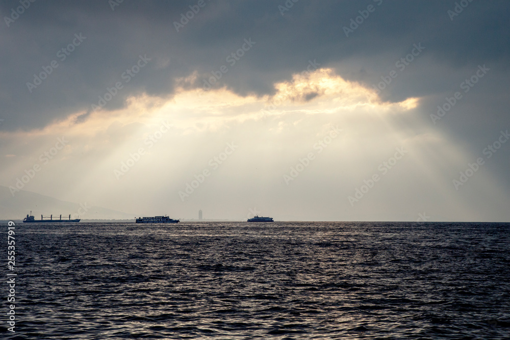Cloudy sunset. Ferryboat at sunset with seagull in izmir gulf, Turkey. 