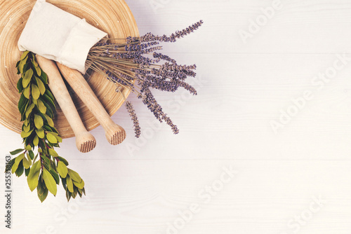 Plate, lavander, two pastles, laurel on wooden background. photo