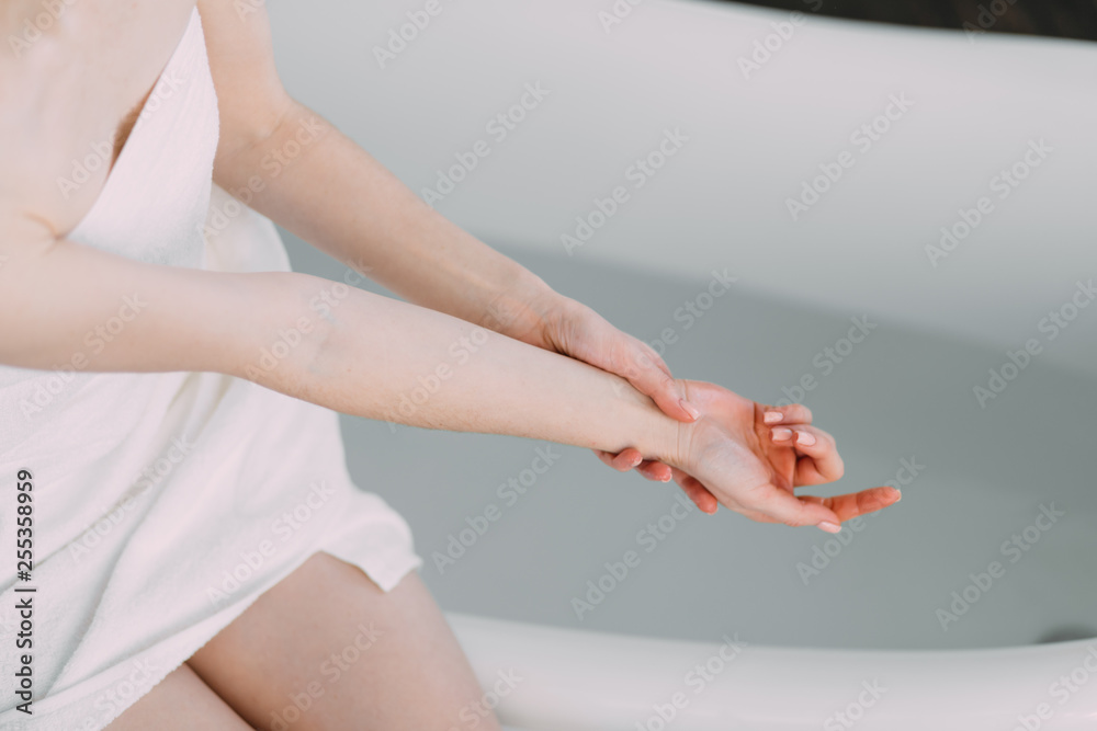 Naklejka premium Morning routine of redhead beauty in the bathroom. Woman running bath, wants to refresh in the water.