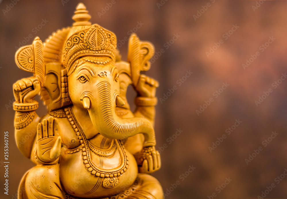 Ganesha statue with wooden background