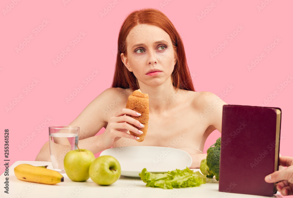 Unhappy red-haired teenage girl in love broke up with her boyfriend and being deeply depressed, healing his heartbreak with food and novels. Unhappy red-haired teenage girl in love broke up with her boyfriend and being deeply depressed, healing his heartbreak with food and novels.
