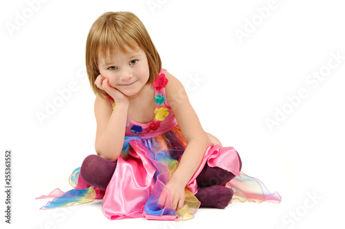 Sitting girl in a colorful dress