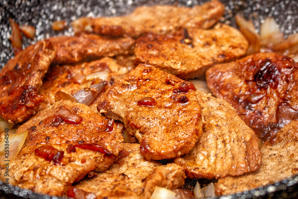 Cooking fryed meat on the pan with onion close up Cooking fryed meat on the pan with onion close up