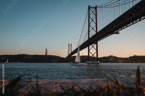 view of the 25th April bridge at sunset in Lisbon, Portugal © Tomas