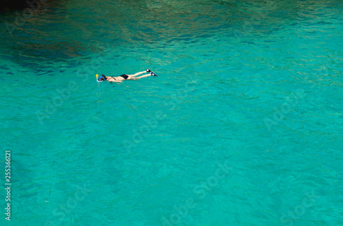 snorkeler woman in blue turiquoise water