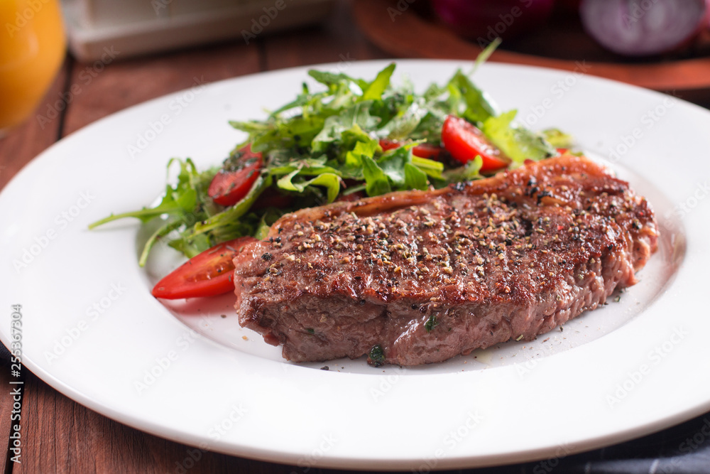 Beef steak with vegetables. Barbecue meat beef tenderloin. wooden background Beef steak with vegetables. Barbecue meat beef tenderloin. wooden background