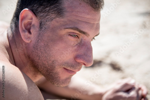 Attractive man posing on the beach