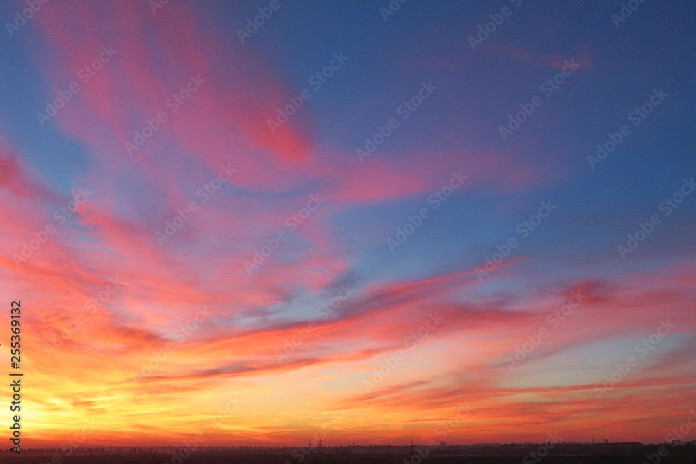 Beautiful red fiery sunset background over the city, flame in the sky 