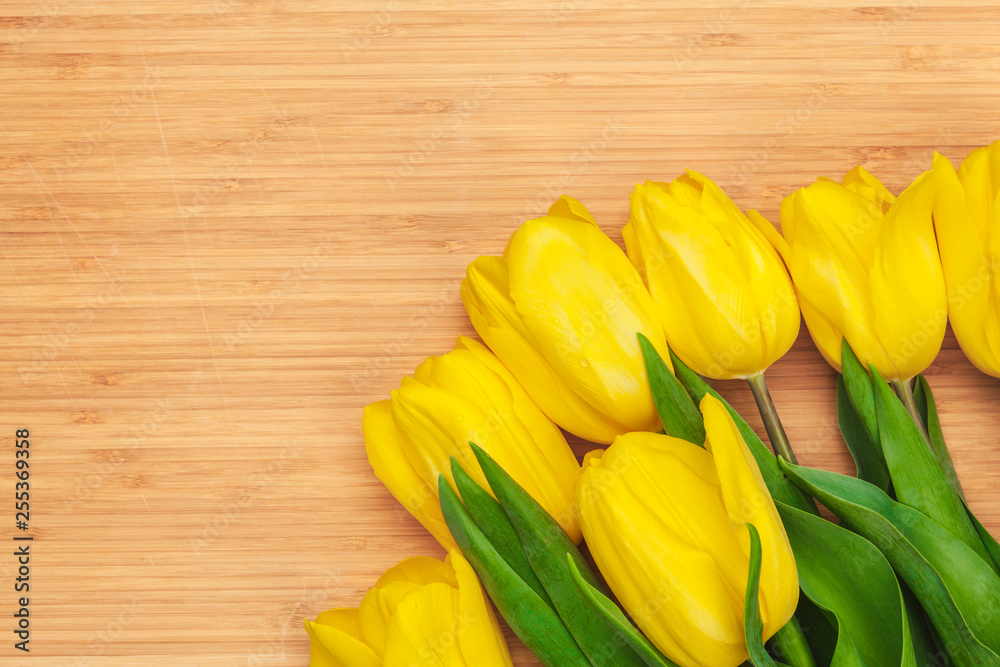 Womens day. Tulips bouquet on wooden planks background, copy space, top view Womens day. Tulips bouquet on wooden planks background, copy space, top view
