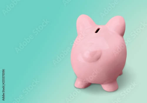 Pink ceramic piggy bank with copy space alongside in a conceptual financial image