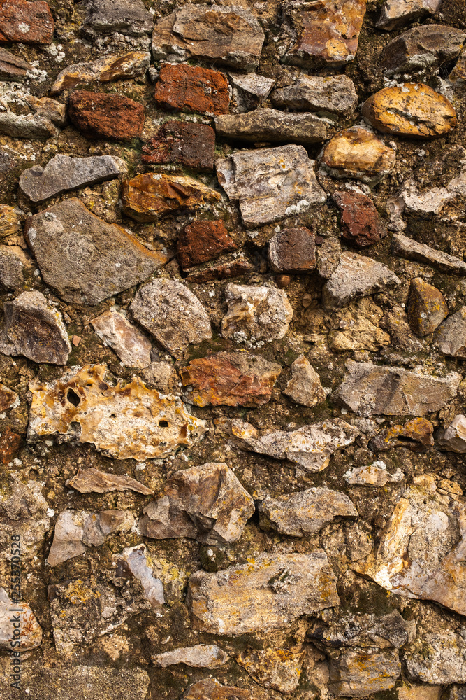 A close up of a wall made of large rocks and cement, great for a background or wallpaper