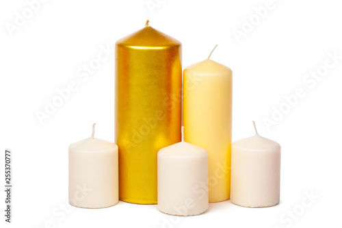 Golden and white colored candles isolated on white background