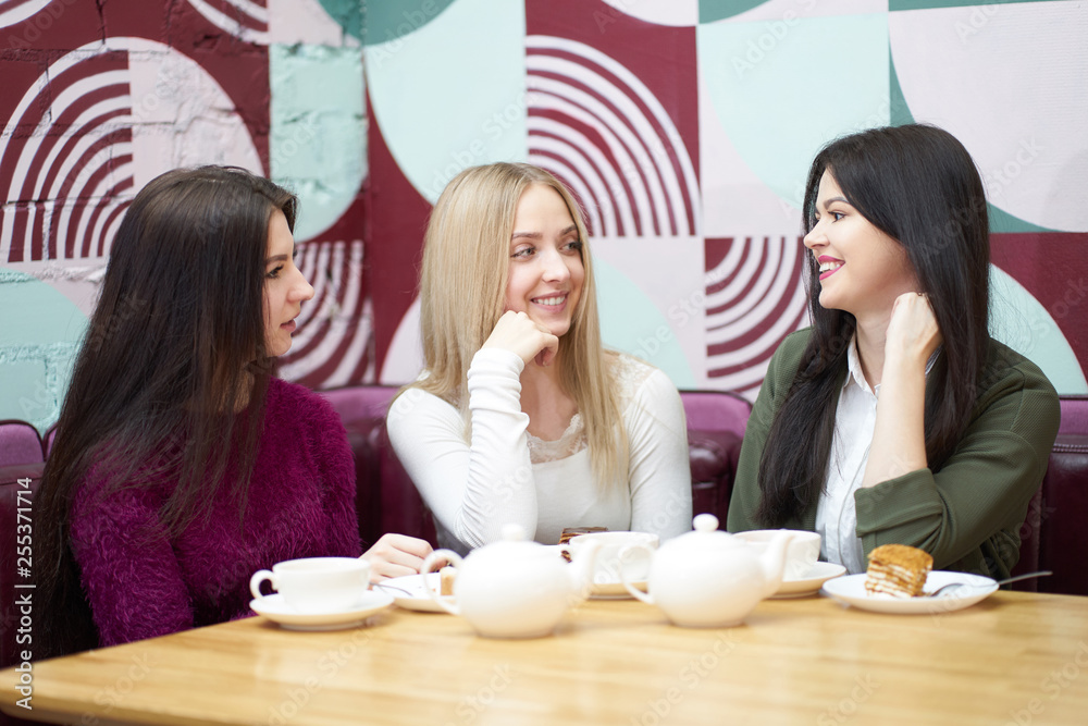 Girlfriends have a talk in cafe during teatime