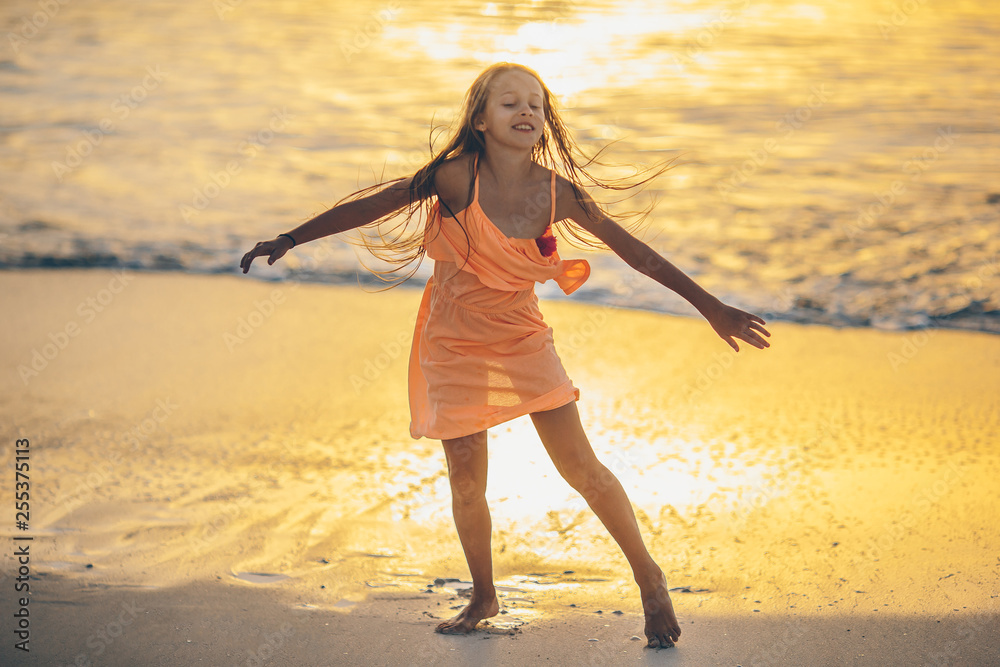 Adorable happy little girl on white beach at sunset. Stock Photo ...
