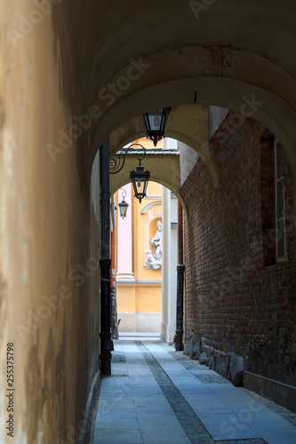 narrow street with lamps to the St. Martin s Church architectural details in Warsaw Old Town