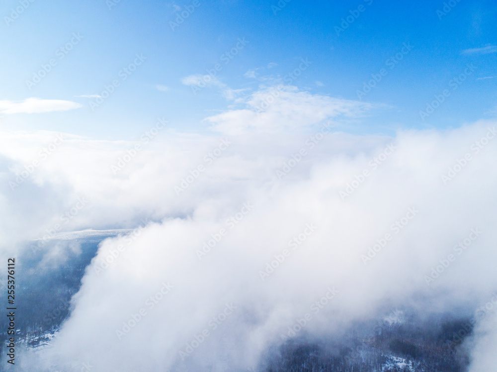 Aerial view White clouds in blue sky. Top view. View from drone. Aerial bird's eye view. Aerial top view cloudscape. Texture of clouds. View from above.