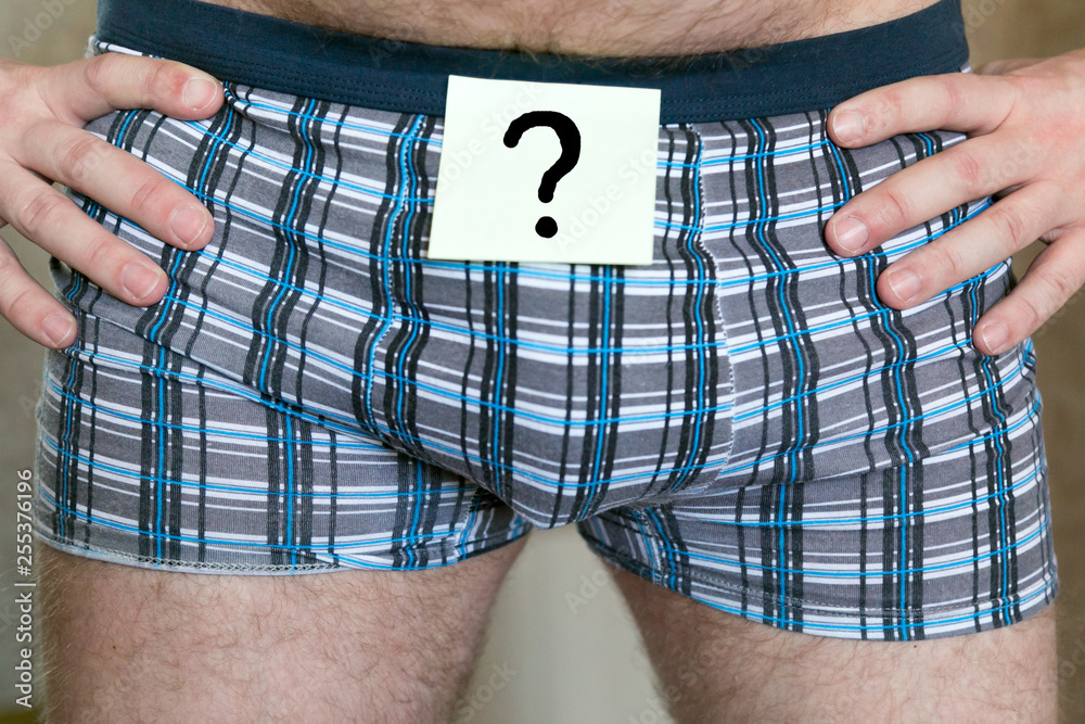 Question mark on a sticker of men's panties. The question on paper glued to  men's underwear. Stock Photo