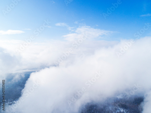 Aerial view White clouds in blue sky. Top view. View from drone. Aerial bird's eye view. Aerial top view cloudscape. Texture of clouds. View from above.