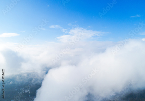Fototapeta Naklejka Na Ścianę i Meble -  Aerial view White clouds in blue sky. Top view. View from drone. Aerial bird's eye view. Aerial top view cloudscape. Texture of clouds. View from above.