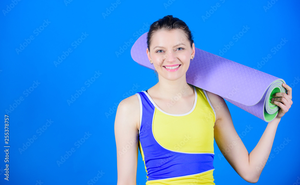 Sporty woman training in gym. Sport mat equipment. Athletic fitness. Strong muscles and power. Health diet. Success. Happy woman workout with fitness mat. copy space. Getting into the yoga groove Sporty woman training in gym. Sport mat equipment. Athletic fitness. Strong muscles and power. Health diet. Success. Happy woman workout with fitness mat. copy space. Getting into the yoga groove