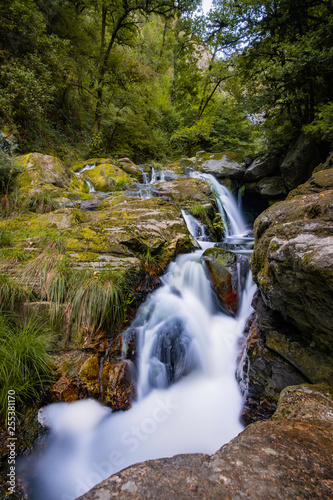 Fototapeta Naklejka Na Ścianę i Meble -  Silk effect of the water of a beautiful waterfall in a river. Pontevedra, Galicia, Spain. 
