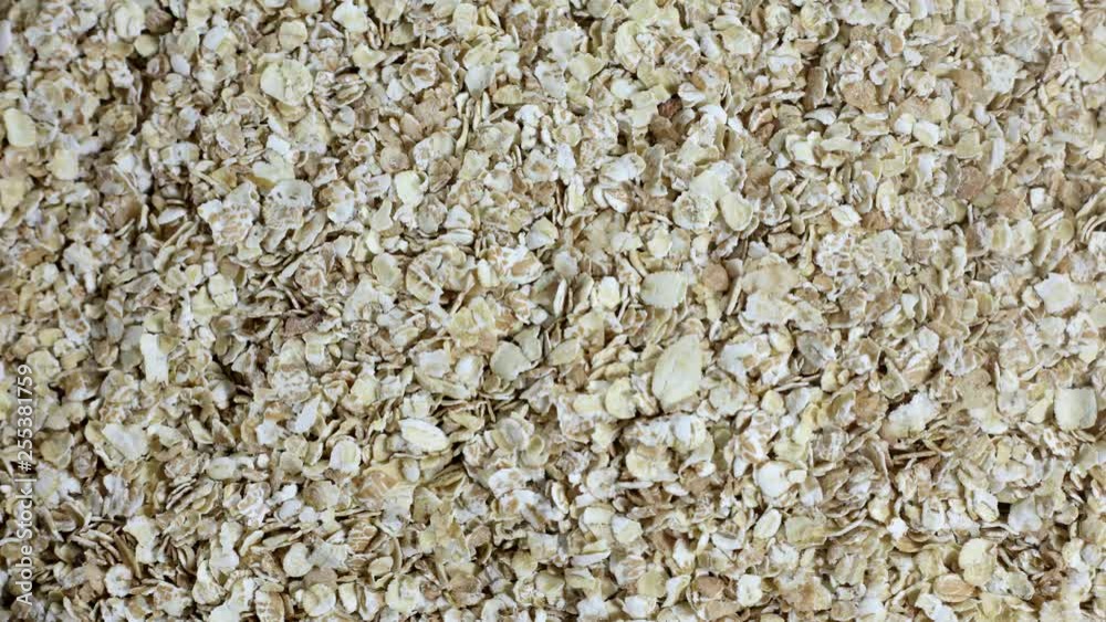 Dried oat flackes or oatmeal in stop motion. Cooking healthy food. Background
