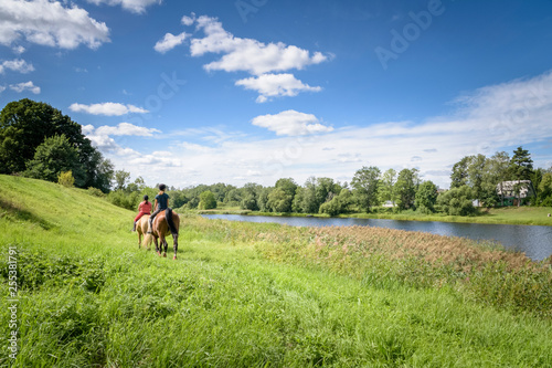 Two girls riding their horses friendship in the beautiful green and lush Estonia © Wouter