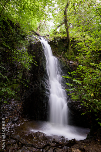 Angel white waterfall in lush and green forest England © Wouter