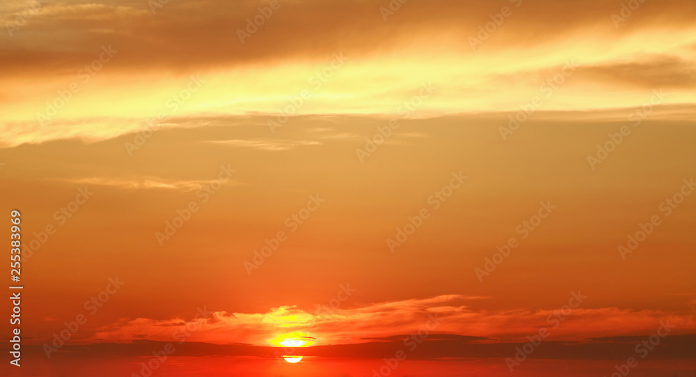 Landscape of colorful dramatic sky clouds in rays of sunset light, beautiful nature background