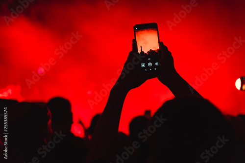 spectators at a concert phone close-up live broadcast
