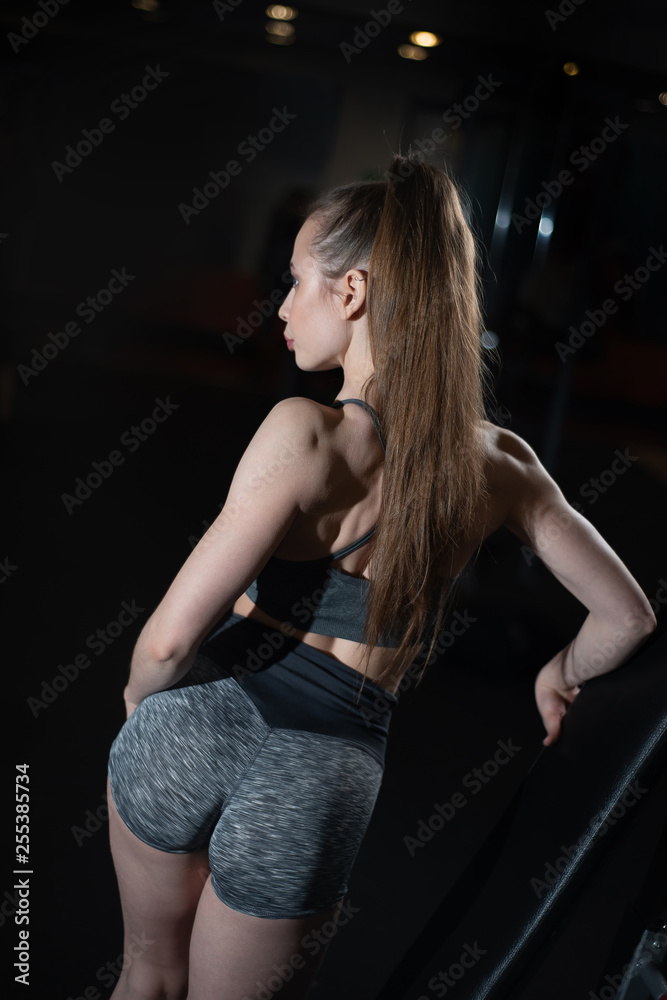 Girl posing in the gym showing off her buttocks Girl posing in the gym showing off her buttocks