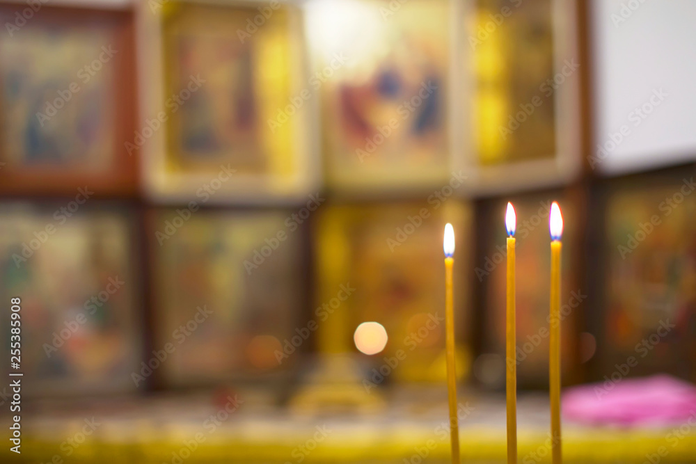 Church candles on the background of blurry icons. Church Projects Background