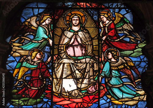 Virgin Mary surrounded by angels, stained glass window in Orsanmichele Church in Florence, Tuscany, Italy