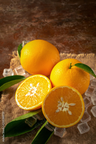 Fresh orange on a wooden table background © kaiskynet