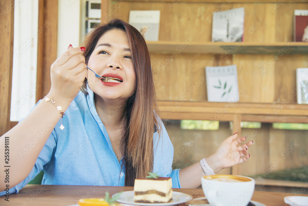 Portrait happy young Asian lady in coffee shop - woman in relax time concept Portrait happy young Asian lady in coffee shop - woman in relax time concept