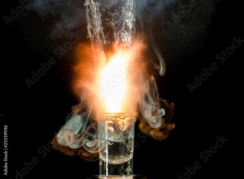 Fototapeta Naklejka Na Ścianę i Meble -  The explosion of water in a glass on a black background. High burst