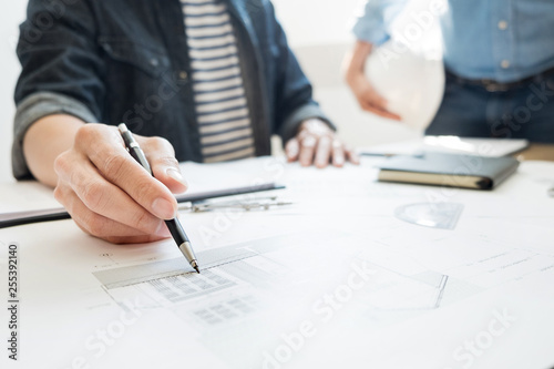 Engineer discussing meeting working on blueprint project architectural at construction site.